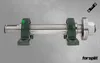 A metal shaft supported by two green bearing blocks, with a nut and flange on one end, set against a grey background. Produktbild-Vorschau
