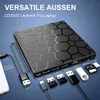 A black external CD/DVD drive with a hexagonal pattern on its surface, connected to a laptop via USB-C and USB-A cables. Various USB adapters and memory cards are also displayed. Produktbild-Vorschau