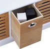 A close-up view of an open drawer in a wooden and white storage unit, revealing two small boxes inside. Produktbild-Vorschau