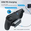 A Steam Deck is shown docked and connected to a power source via a USB-C cable, illustrating charging capabilities. Produktbild-Vorschau