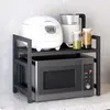 A kitchen counter with a microwave stand holding a rice cooker, a kettle, and jars of food. Náhľad obrázku produktu