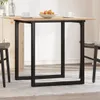 A dining table with a wooden top and black metal legs, set in a room with a light-colored rug and a hint of a cabinet in the background. Produktbild-Vorschau