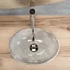 A close-up overhead view of a grey oval countertop sink with a silver faucet. Podgląd zdjęcia produktu