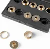 A set of brass router template bushings in a black plastic holder, with a few loose bushings in the foreground. Produktbild-Vorschau