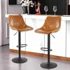 Two brown leather bar stools are shown in a modern kitchen or bar setting. Produktbild-Vorschau