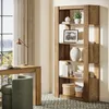 A home office or living room setting with a wooden bookshelf filled with decor and books, a desk with a lamp and an open book, and a green chair. Anteprima dell’immagine prodotto