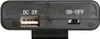 Close-up view of the side of a black electronic device, showing a USB port and an on/off switch. Podgląd zdjęcia produktu