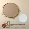 The back of a round mirror with a decorative frame and a close-up of a textured pattern. Voir les images du produit