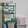 A green metal shelving unit filled with various storage boxes containing household items. Produktbild-Vorschau