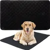 A golden retriever dog lying on a black training pad, with another black training pad behind it. Náhľad obrázku produktu