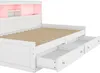 A white daybed with drawers pulled out, showing the slatted mattress base and a pink ambient light in the headboard. Voir les images du produit