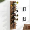 A rustic wooden wine rack mounted on a white wall, holding several wine bottles. Produktbild-Vorschau