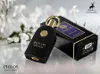 A black perfume bottle and its box are displayed with white flowers in the background. Voir les images du produit