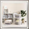 A collection of storage baskets and books arranged in a room setting with shelves and a small table. Anteprima dell’immagine prodotto