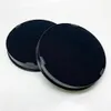 Two black circular items with fabric texture are shown in a studio setting against a white background. Anteprima dell’immagine prodotto