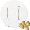 A white mold with text and a group of small, hive-shaped pasta pieces in the foreground. Anteprima dell’immagine prodotto