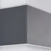 Close-up of a corner of a dark gray textured exterior light fixture with a white trim. Produktbild-Vorschau