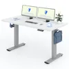 A white adjustable standing desk with two computer monitors, a keyboard, mouse, headphones, a plant, a coffee cup illustration, and a blue satchel hanging from the side. Podgląd zdjęcia produktu