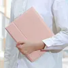A person holding a pink tablet case. Náhľad obrázku produktu