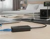 A desk setup with a laptop, tablet, and network adapter in a bedroom setting. Produktbild-Vorschau