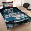 A bed with a duvet cover and pillow featuring a graphic of Volkswagen buses on a street at night. Náhľad obrázku produktu
