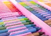 A close-up view of an open art supply case, showing rows of colorful crayons and markers. Anteprima dell’immagine prodotto