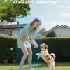 A woman is playing with her dog in a backyard. Produktbild-Vorschau
