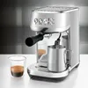 A silver Sage espresso machine is shown on a white countertop with a glass of espresso and a milk frothing pitcher. Produktbild-Vorschau