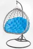 A hanging egg chair with a blue cushion, shown against a white background. Podgląd zdjęcia produktu