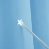 A close-up view of a blue curtain with a star-shaped cutout and a gray string passing through it. Voir les images du produit