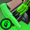 A green cleaning brush is shown being used to clean car air vents, with a circular green graphic in the lower left corner. Podgląd zdjęcia produktu