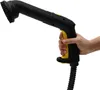 A hand holding a black and yellow steam cleaner with a brush attachment. Náhled obrázku produktu
