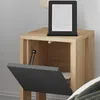 A wooden nightstand with its door open, showing the interior. An e-reader is placed on top of the nightstand. Podgląd zdjęcia produktu