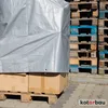A silver tarp covers boxes on a pallet, with stacks of wooden pallets in the background. Produktbild-Vorschau