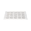 A white tray with multiple circular compartments, each containing a small, round, metallic object. Anteprima dell’immagine prodotto