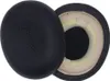 Two black ear pads for headphones are shown against a white background. One ear pad is shown from the outside, and the other is shown from the inside, revealing the foam padding. Voir les images du produit
