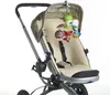 A baby stroller with a toy mobile hanging from the canopy. Voir les images du produit