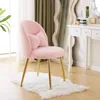 A pink plush chair with gold legs and a bow pillow sits on a white rug in front of a vanity and a mirror. Podgląd zdjęcia produktu