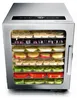 A stainless steel food dehydrator filled with various sliced fruits and vegetables on multiple trays. Podgląd zdjęcia produktu
