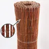 A rolled-up privacy screen made of willow branches, held together by wire and string, against a white background. A close-up inset shows the wire binding. Produktbild-Vorschau