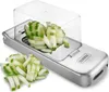 A stainless steel vegetable slicer with chopped cucumber pieces. Náhled obrázku produktu