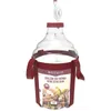 A clear studio shot of a 25-liter wine demijohn with a red label and carrying straps, featuring an airlock at the top. Produktbild-Vorschau