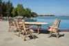 Teak garden chairs and table set by an infinity pool with the ocean in the background. Produktbild-Vorschau