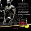 A muscular bodybuilder is shown in a gym setting, holding a weight plate. A product container of creatine monohydrate is also visible, along with text describing its benefits. Náhled obrázku produktu