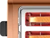 A close-up shot of a copper toaster with two slices of bread inside. Anteprima dell’immagine prodotto