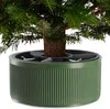 A close-up view of the base of a Christmas tree, showing the trunk and its stand. Podgląd zdjęcia produktu