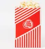 A red and white striped popcorn bag filled with popcorn, set against a white background. Produktbild-Vorschau