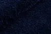 A close-up view of a dark blue, shaggy rug. Voir les images du produit