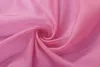 A close-up of pink fabric, folded into a swirl. Produktbild-Vorschau