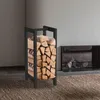 A black metal firewood rack filled with logs stands on a textured brown rug next to a modern fireplace. Anteprima dell’immagine prodotto